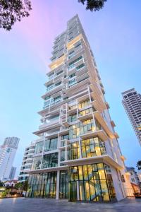 a tall white building with many windows at Sunrise Gurney Premium Executive City/Seafront suite - Penang in George Town