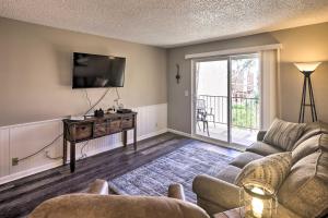 a living room with a couch and a tv at Lake Havasu City Condo with Resort Amenities! in Lake Havasu City
