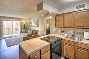 a kitchen with a sink and a stove top oven at Lake Havasu City Condo with Resort Amenities! in Lake Havasu City