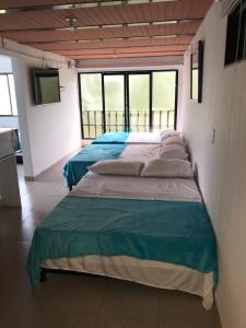 Postel nebo postele na pokoji v ubytování Hotel Buganvilla