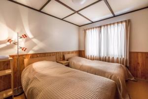 Una cama o camas en una habitación de Midori House - walking distance to Rusutsu Resort 9 fotos más