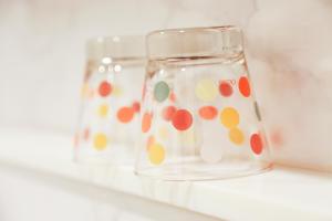 a glass jar with polka dots on it sitting on a shelf at Studio Nana by iCheck inn in Bangkok
