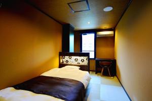 a small bedroom with a bed and a window at Mount View Hakone in Hakone