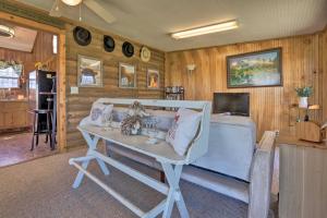 a living room with a couch and a table at Highland Haven Cabin on Working Cattle Farm! 