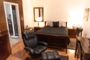 a bedroom with a bed and a chair at Cozy private Guest House in Los Angeles