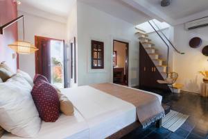 Кровать или кровати в номере Rambutan Resort – Siem Reap
