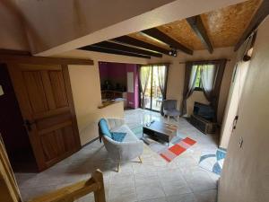 a living room with a couch and a chair at LES VETYVERS in Grande Ravine
