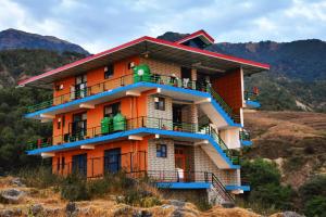 a building on the side of a hill at ANAVЯIN HOME STAYS in Pālampur