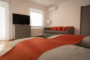 a living room with a bed and a couch at CLAUS RESCH APPARTEMENTS in Leutschach