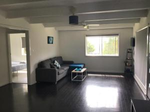 a living room with a couch and a window at Ocean View Villas in Vincentia +23 photos