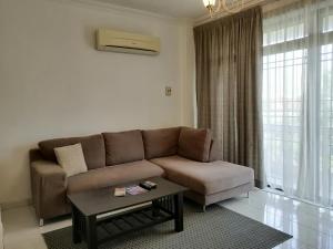 a living room with a couch and a coffee table at Noble Villa Apartment in George Town