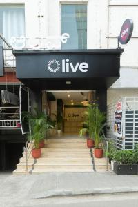 a shop with a black entrance with potted plants at Olive Rest House Road by Embassy Group in Bangalore