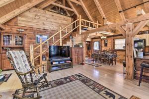 a living room and dining room in a log cabin at West Danville Cabin Day Trip to Stowe Mtn! in Hardwick