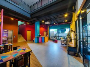a room with tables and a playground in a restaurant at Rumaruma Farvet Residence @ Ambon in Ambon
