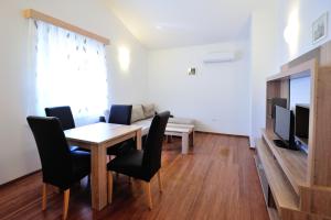 a living room filled with furniture and a tv at Apartments Old Bridge in Mostar