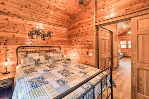 a bedroom with a bed in a log cabin at Charming New Bern Log Cabin - Pets Welcome! in New Bern