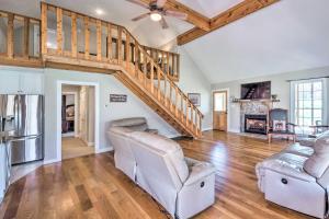 a living room with two chairs and a staircase at Bright Green Gables Cabin Hike, Swim and BBQ in Lewisburg
