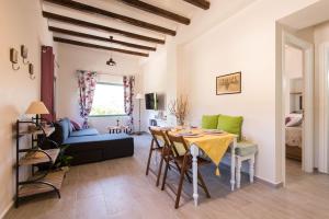 a kitchen and living room with a table and chairs at Mandarinies Boutique Residence in Kalymnos