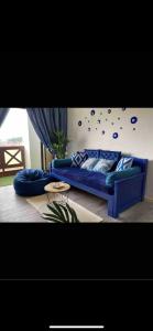 a living room with a blue couch and a table at Century Mahkota Apartments in Melaka