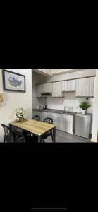 a kitchen with a wooden table and a table and chairs at Century Mahkota Apartments in Melaka