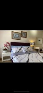 a bedroom with a large bed with flowers on it at Century Mahkota Apartments in Melaka