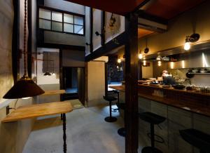 a man in the kitchen of a restaurant at UNKNOWN KYOTO in Kyoto
