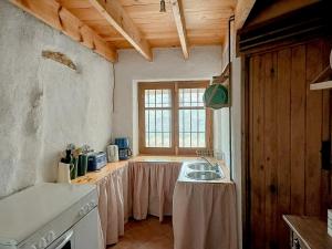 a kitchen with a table and a sink in it at Cortijo Vacas Gordas Villas in Castell de Ferro