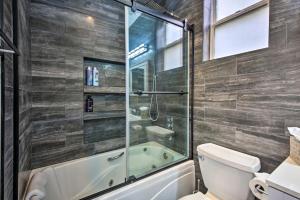 a bathroom with a tub and a toilet at Torrey Spa Suite Modern San Diego Studio! in San Diego