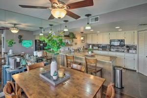 a kitchen with a wooden table and a dining room at Bullhead City Condo with Direct River Access! in Bullhead City