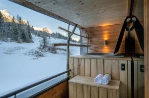a sauna with a view of a snow covered field at mama thresl in Leogang