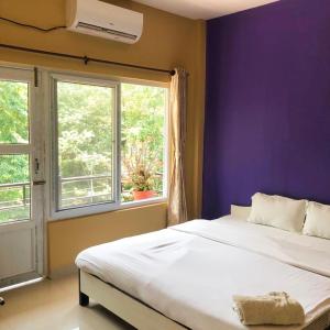 מיטה או מיטות בחדר ב-Hotel Rhinoceros-Homestay