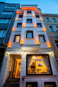 a tall building with lights on the front of it at Nacre Residence in Istanbul