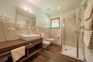 a bathroom with a sink and a toilet and a shower at Fewo Sonnenaufgang - Zeppichl in Pfelders