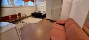 a living room with a couch and a bed at Apartments Puistokatu in Savonlinna