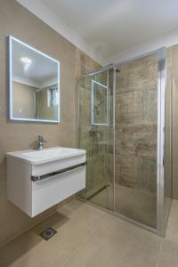 a bathroom with a sink and a shower at Blue Pearl Apartment in Cres +24 photos