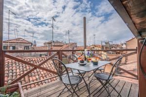 una mesa y sillas en un balcón con vistas en Cà Grassi 3 Venetian Terrace, en Venecia