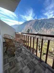 a balcony with a bench and a view of a mountain at Sarthak Home Stay, Beautiful Valley view of Mountain in Jagatsukh +23 photos