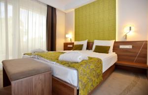 a hotel room with a large bed and a window at Imola Hotel Platán - Adults Only in Eger