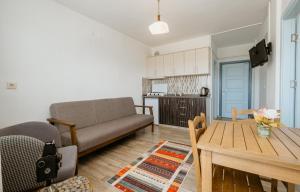 a living room with a couch and a table at Azra Apart & Otel in Gokceada Town