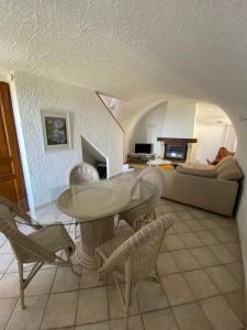 a living room with a table and chairs and a couch at Levé du soleil sur la mer in Taglio-Isolaccio +27 photos