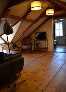 a living room with a couch and a tv at Villa Iolanda in Merano