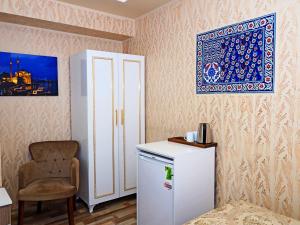 a room with a refrigerator and a chair and a picture at Nagehan Hotel Old City in Istanbul