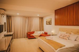 a hotel room with a bed and a couch at Canoe and Fishing , Free Pickup in Batam Center