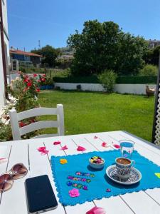 a table with a plate of food and a cup of coffee at Azra Apart & Otel in Gokceada Town