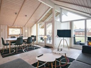 a living room with a table and chairs at Holiday home Asaa V in Aså