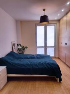 a bedroom with a bed and a large window at Apartament Rokosowska in Warsaw