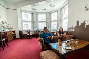 a man and a woman sitting in a room at Vienna Boutique - Premium Hostel in Vienna