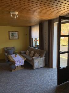 a living room with a couch and a table at Ferienwohnung Agnes Mayer in Riedenburg