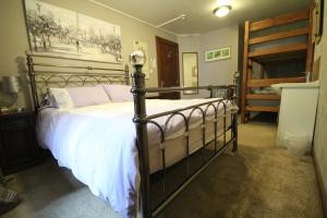 a bedroom with a large bed and a bunk bed at Lledr House Hostel near two Zip World sites in Dolwyddelan +41 photos