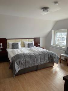 a bedroom with a large bed in a room at Ostsee Hotel Travemünde in Travemünde